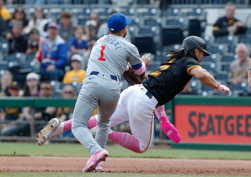 May 12, 2024; Pittsburgh, Pennsylvania, USA;  Chicago Cubs second baseman Nick Madrigal (1) tags Pittsburgh Pirates right fielder Connor Joe (2) out on a caught stealing run down between first and second bases during the fourth inning at PNC Park. Mandatory Credit: Charles LeClaire-USA TODAY Sports