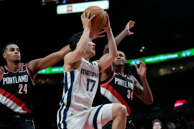 PORTLAND, OREGON - NOVEMBER 10: Yuki Kawamura #17 of the Memphis Grizzlies drives for the basket between Jabari Walker #34 and Kris Murray #24 of the Portland Trail Blazers during the second half at Moda Center on November 10, 2024 in Portland, Oregon. NOTE TO USER: User expressly acknowledges and agrees that, by downloading and or using this photograph, User is consenting to the terms and conditions of the Getty Images License Agreement. (Photo by Soobum Im/Getty Images)