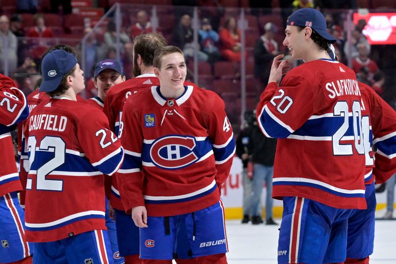 Apr 16, 2024; Montreal, Quebec, CAN; Montreal Canadiens forward Cole Caufield (22) and teammates defenseman Lane Hutson (48) and forward Juraj Slafkovsky (20) after a game against the Detroit Red Wings at the Bell Centre. Mandatory Credit: Eric Bolte-USA TODAY Sports