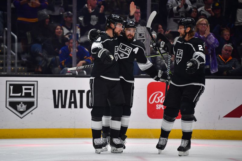 Feb 13, 2023; Los Angeles, California, USA; Los Angeles Kings right wing Adrian Kempe (9) celebrates his short handed goal scored against the Buffalo Sabres with defenseman Drew Doughty (8) and defenseman Alexander Edler (2) during the second period at Crypto.com Arena. Mandatory Credit: Gary A. Vasquez-USA TODAY Sports