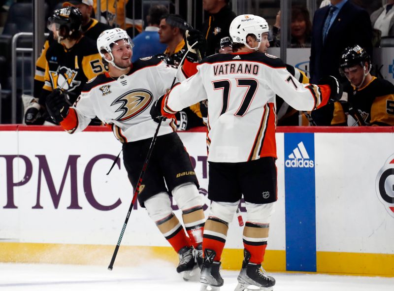 Oct 30, 2023; Pittsburgh, Pennsylvania, USA;  Anaheim Ducks center Mason McTavish (left) reacts with right wing Frank Vatrano (77) after scoring a game winning short-handed goal against the Pittsburgh Penguins during the third period at PPG Paints Arena. Anaheim won 4-3. Mandatory Credit: Charles LeClaire-USA TODAY Sports