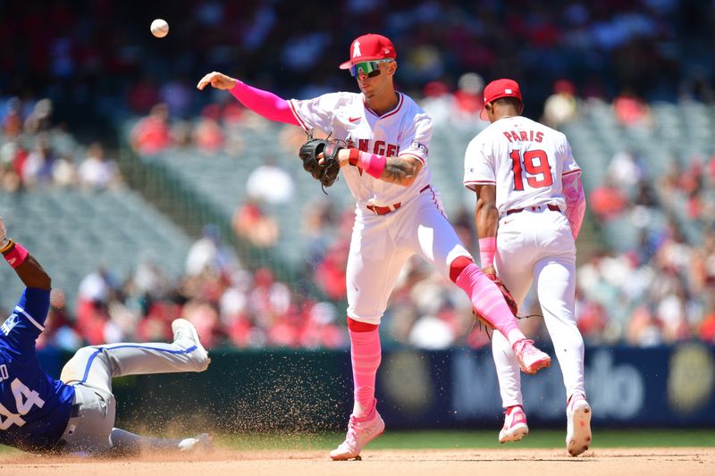 May 12, 2024; Anaheim, California, USA; Kansas City Royals left fielder Dairon Blanco (44) is out at second as Los Angeles Angels shortstop Zach Neto (9) throws to first for the out against right fielder Hunter Renfroe (16) during the sixth inning at Angel Stadium. Mandatory Credit: Gary A. Vasquez-USA TODAY Sports