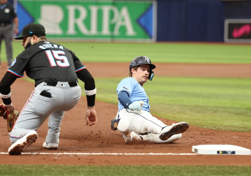Jul 31, 2024; St. Petersburg, Florida, USA;  Tampa Bay Rays outfielder Jonny DeLuca (21) slides in to third base after hitting a RBI triple against the Miami Marlins during the second inning at Tropicana Field. Mandatory Credit: Kim Klement Neitzel-USA TODAY Sports