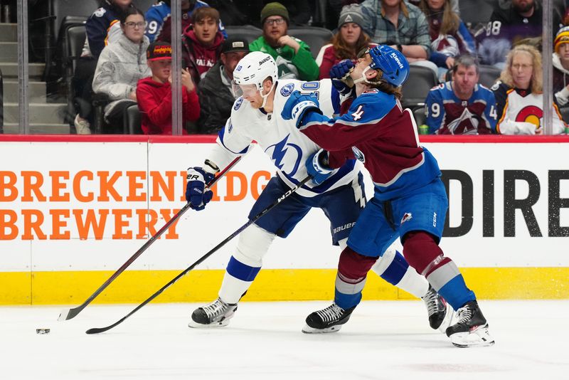 Feb 14, 2023; Denver, Colorado, USA; Tampa Bay Lightning right wing Corey Perry (10) pushes at Colorado Avalanche defenseman Bowen Byram (4) in first period at Ball Arena. Mandatory Credit: Ron Chenoy-USA TODAY Sports