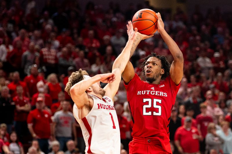 Mar 3, 2024; Lincoln, Nebraska, USA; Rutgers Scarlet Knights guard Jeremiah Williams (25) shoots a 3-point shot against Nebraska Cornhuskers guard Sam Hoiberg (1) during the second half at Pinnacle Bank Arena. Mandatory Credit: Dylan Widger-USA TODAY Sports