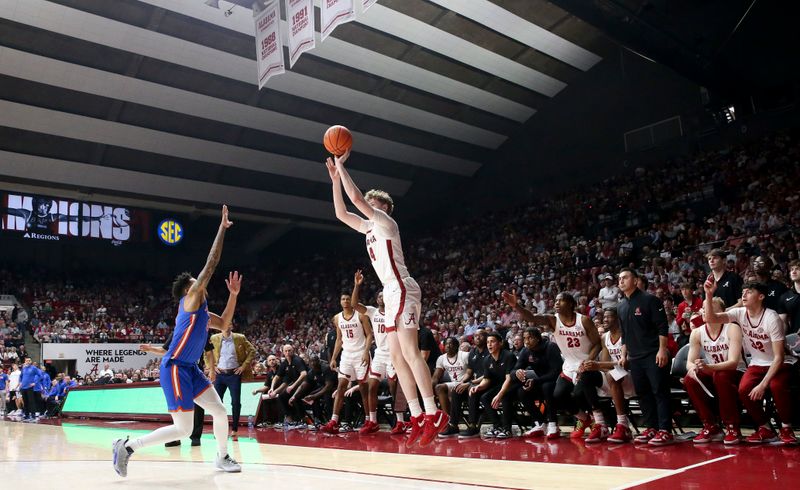 Feb 21, 2024; Tuscaloosa, Alabama, USA; Alabama Crimson Tide forward Sam Walters (24) hits a three point basket in the second half over Florida Gators guard Will Richard (5) at Coleman Coliseum. Mandatory Credit: Gary Cosby Jr.-USA TODAY Sports