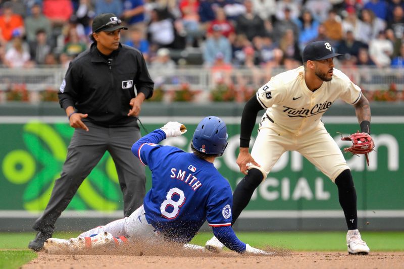 May 26, 2024; Minneapolis, Minnesota, USA;  Texas Rangers infielder Josh H. Smith (8) slides safely into second base with a double as Minnesota Twins infielder Carlos Correa (4) awaits the throw during the fifth inning at Target Field. Mandatory Credit: Nick Wosika-USA TODAY Sports