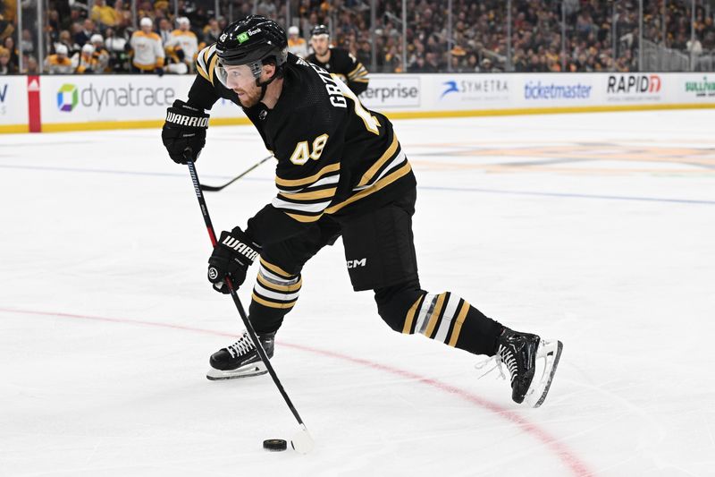 Oct 14, 2023; Boston, Massachusetts, USA; Boston Bruins defenseman Matt Grzelcyk (48) takes a shot against the Nashville Predators during the second period at the TD Garden. Mandatory Credit: Brian Fluharty-USA TODAY Sports