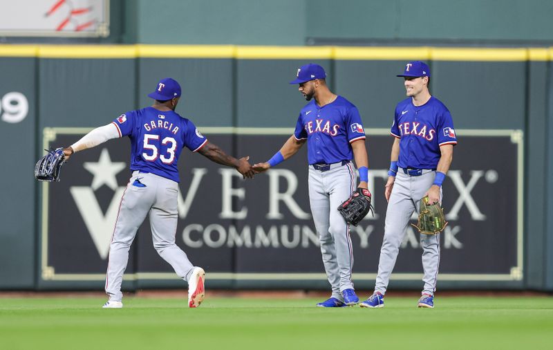 Apr 12, 2024; Houston, Texas, USA; Texas Rangers right fielder Adolis Garcia (53) celebrates with center fielder Leody Taveras (3) after the game against the Houston Astros at Minute Maid Park. Mandatory Credit: Troy Taormina-USA TODAY Sports