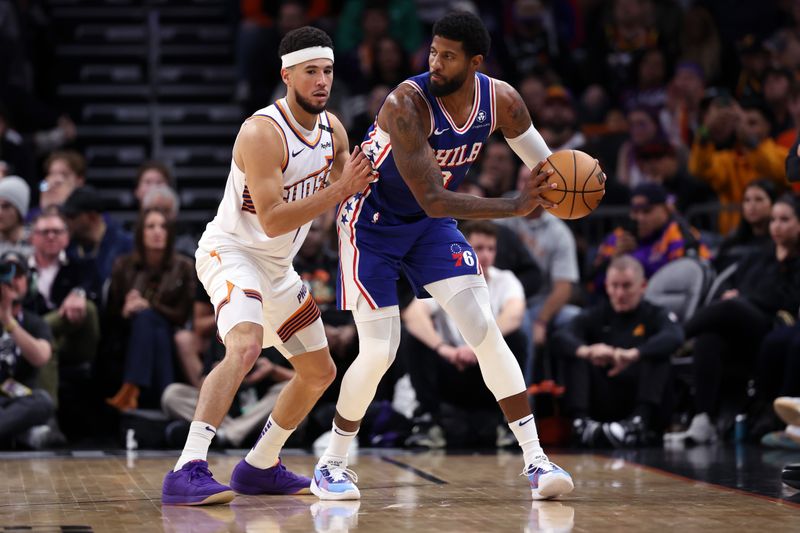 PHOENIX, ARIZONA - NOVEMBER 04: Paul George #8 of the Philadelphia 76ers posts up on Devin Booker #1 of the Phoenix Suns during the second half at Footprint Center on November 04, 2024 in Phoenix, Arizona. NOTE TO USER: User expressly acknowledges and agrees that, by downloading and or using this photograph, User is consenting to the terms and conditions of the Getty Images License Agreement.  (Photo by Chris Coduto/Getty Images)