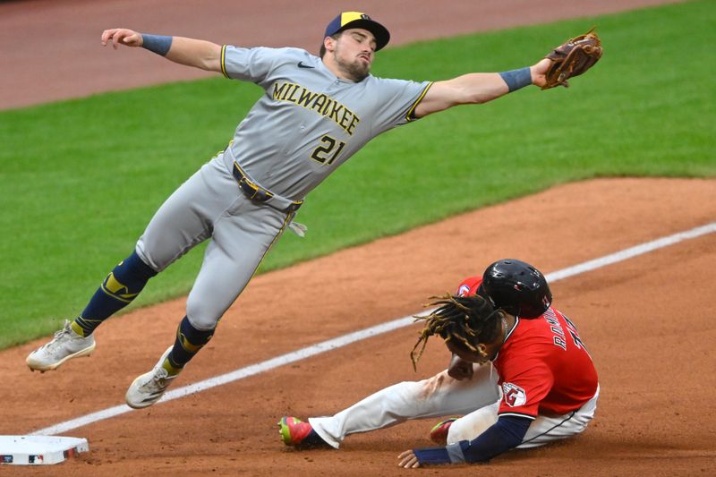 May 12, 2025; Cleveland, Ohio, USA; Cleveland Guardians third baseman Jose Ramirez (11) steals third base beside Milwaukee Brewers third baseman Caleb Durbin (21) in the sixth inning at Progressive Field. Mandatory Credit: David Richard-Imagn Images