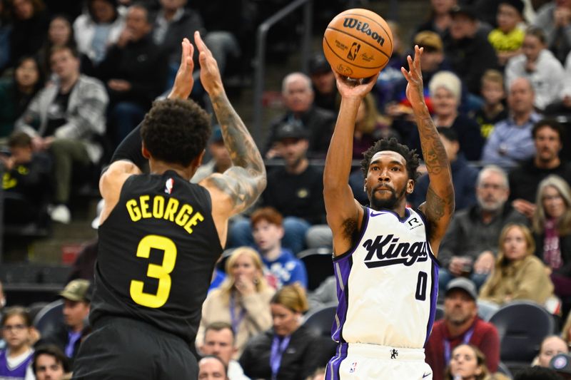 SALT LAKE CITY, UTAH - OCTOBER 29: Malik Monk #0 of the Sacramento Kings shoots over Keyonte George #3 of the Utah Jazz during the first half of a game at Delta Center on October 29, 2024 in Salt Lake City, Utah. NOTE TO USER: User expressly acknowledges and agrees that, by downloading and or using this photograph, User is consenting to the terms and conditions of the Getty Images License Agreement.  (Photo by Alex Goodlett/Getty Images)