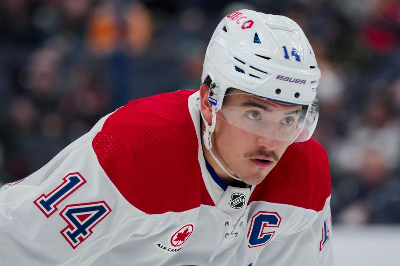 Nov 29, 2023; Columbus, Ohio, USA;  Montreal Canadiens center Nick Suzuki (14) awaits the face-off against the Columbus Blue Jackets in the first period at Nationwide Arena. Mandatory Credit: Aaron Doster-USA TODAY Sports