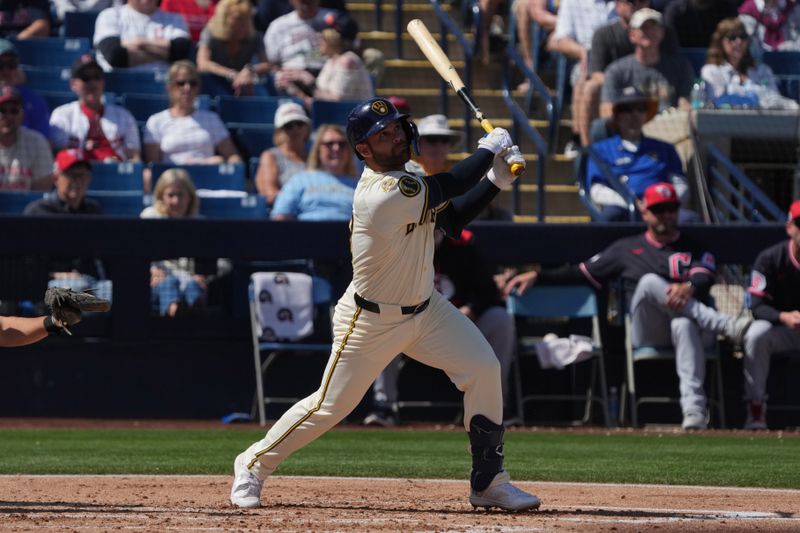 Mar 16, 2025; Phoenix, Arizona, USA; Milwaukee Brewers third base Vinny Capra (18) hits against the Cleveland Guardians in the second inning at American Family Fields of Phoenix. Mandatory Credit: Rick Scuteri-Imagn Images