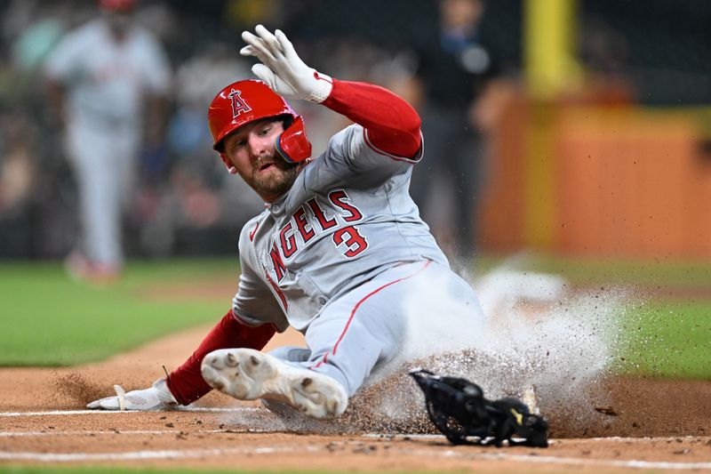 Aug 27, 2024; Detroit, Michigan, USA;  Los Angeles Angels left fielder Taylor Ward (3) slides home safely to score a run against the Detroit Tigers in the first inning at Comerica Park. Mandatory Credit: Lon Horwedel-USA TODAY Sports