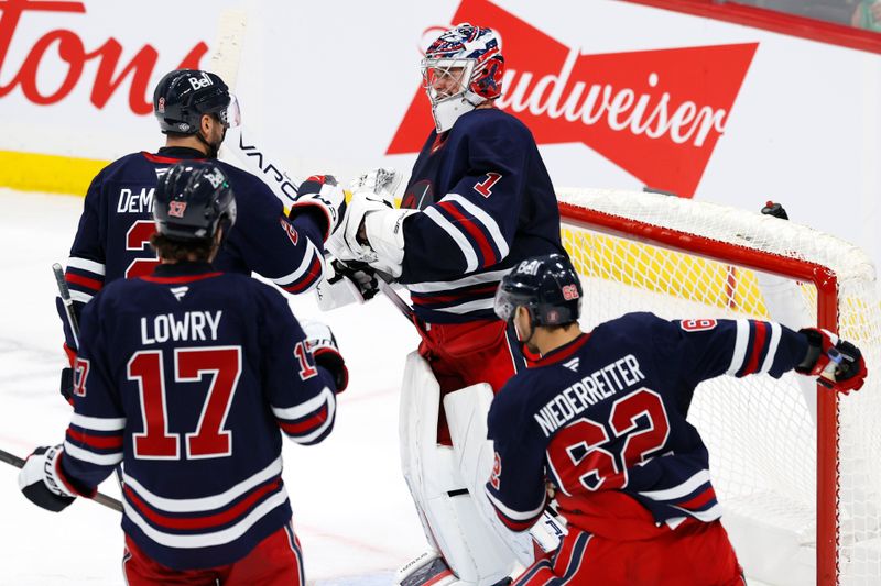 Oct 20, 2024; Winnipeg, Manitoba, CAN; Winnipeg Jets celebrate their victory over the Pittsburgh Penguins at Canada Life Centre. Mandatory Credit: James Carey Lauder-Imagn Images