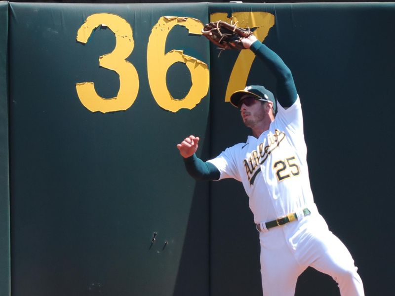 Aug 23, 2023; Oakland, California, USA; Oakland Athletics right fielder Brett Rooker (25) catches the ball along the wall against the Kansas City Royals during the fourth inning at Oakland-Alameda County Coliseum. Mandatory Credit: Kelley L Cox-USA TODAY Sports