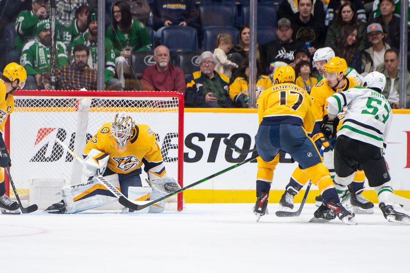 Feb 15, 2024; Nashville, Tennessee, USA; Dallas Stars center Wyatt Johnston (53) scores past Nashville Predators goalie Kevin Lankinen (32) during the third period at Bridgestone Arena. Mandatory Credit: Steve Roberts-USA TODAY Sports