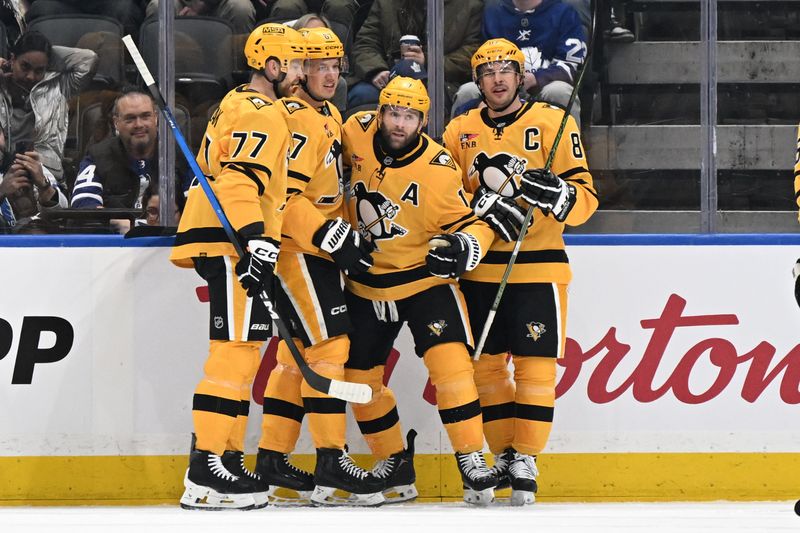 Dec 23, 2025; Toronto, Ontario, CAN; Pittsburgh Penguins forward Bryan Rust (17) celebrates with forwards Sidney Crosby (87) and Rickard Rakell (67) and defenseman Brett Kulak (77) after scoring a goal against the Toronto Maple Leafs in the first period at Scotiabank Arena. Mandatory Credit: Dan Hamilton-Imagn Images