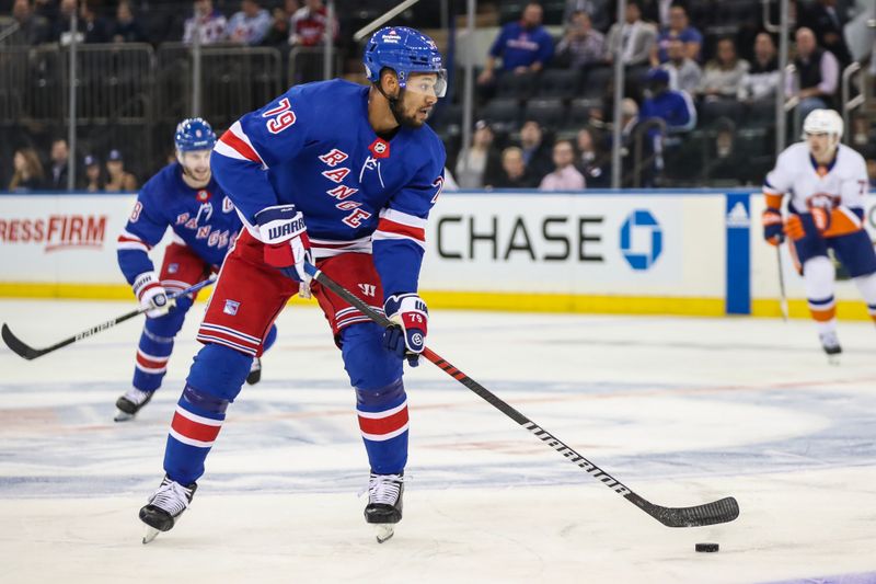 Sep 26, 2023; New York, New York, USA;  New York Rangers defenseman K'Andre Miller (79) controls the puck in the first period against the New York Islanders at Madison Square Garden. Mandatory Credit: Wendell Cruz-USA TODAY Sports