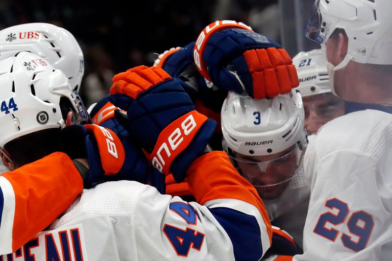 Feb 20, 2024; Pittsburgh, Pennsylvania, USA; New York Islanders defenseman Adam Pelech (3) is swarmed by teammates after scoring the game winning goal in overtime against the Pittsburgh Penguins at PPG Paints Arena. New York won 5-4 in overtime. Mandatory Credit: Charles LeClaire-USA TODAY Sports