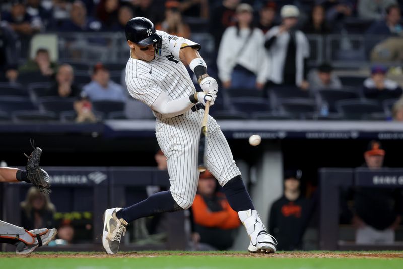 Sep 25, 2024; Bronx, New York, USA; New York Yankees center fielder Aaron Judge (99) hits a three run home run against the Baltimore Orioles during the ninth inning at Yankee Stadium. Mandatory Credit: Brad Penner-Imagn Images