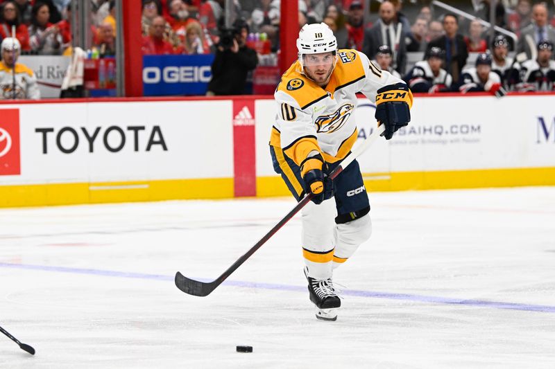 Dec 30, 2023; Washington, District of Columbia, USA; Nashville Predators center Colton Sissons (10) passes the puck against the Washington Capitals during the second period at Capital One Arena. Mandatory Credit: Brad Mills-USA TODAY Sports