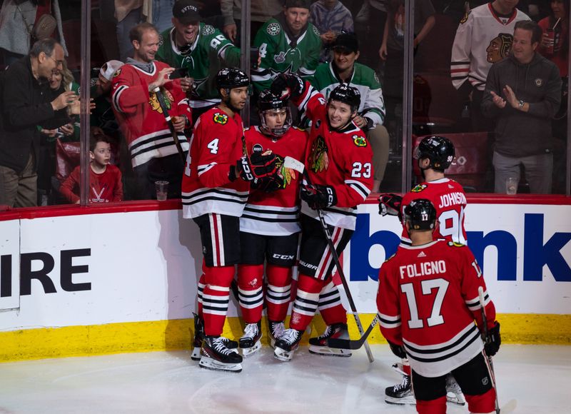 Apr 6, 2024; Chicago, Illinois, USA; Chicago Blackhawks center Connor Bedard (98) celebrates with teammates after scoring a goal against the Dallas Stars during the second period at United Center. Mandatory Credit: Seeger Gray-USA TODAY Sports