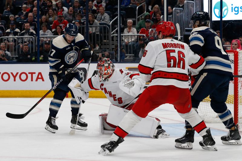 Apr 16, 2024; Columbus, Ohio, USA; Carolina Hurricanes goalie Spencer Martin (41) makes a save as Columbus Blue Jackets right wing Justin Danforth (17) looks for a rebound during the second period at Nationwide Arena. Mandatory Credit: Russell LaBounty-USA TODAY Sports