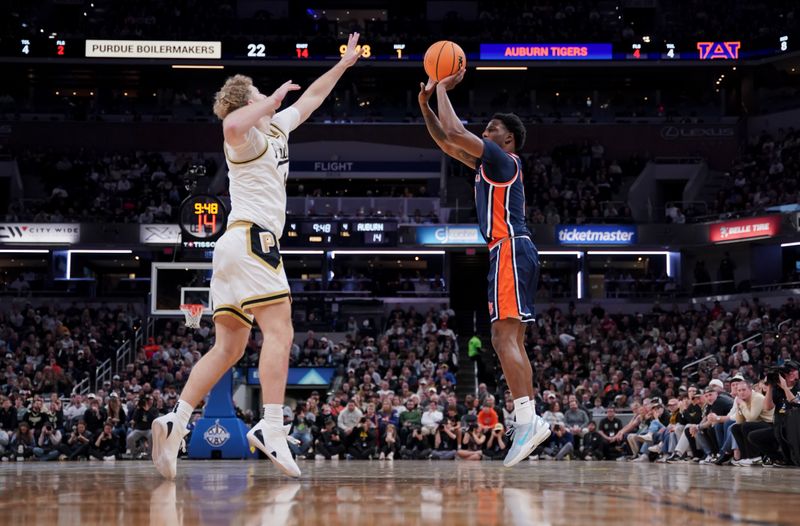 Dec 20, 2025; Indianapolis, Indiana, USA; Auburn Tigers guard Kevin Overton (1) shoots the ball against Purdue Boilermakers guard Jack Benter (14) during the first half at Gainbridge Fieldhouse. Mandatory Credit: Robert Goddin-Imagn Images