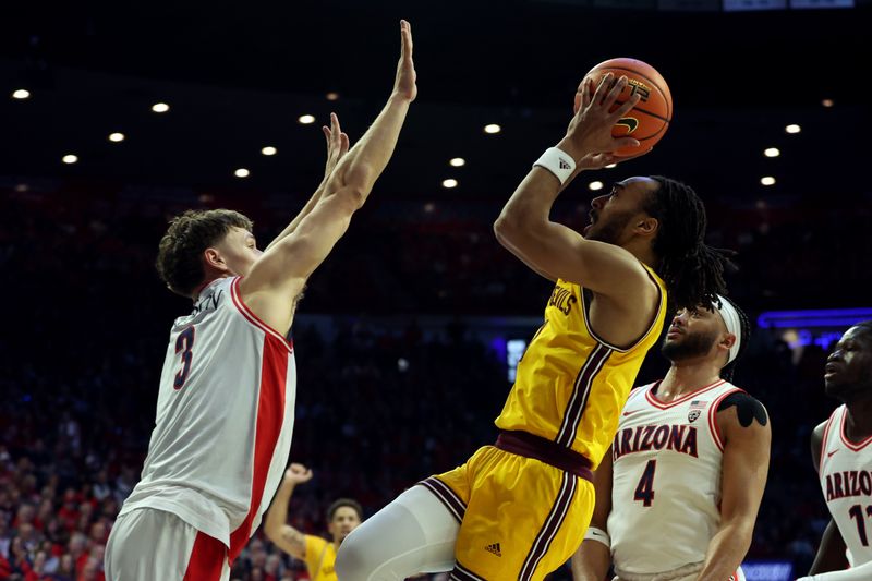 Feb 17, 2024; Tucson, Arizona, USA; Arizona State Sun Devils guard Frankie Collins (1) shoots a basket agaisnt Arizona Wildcats guard Pelle Larsson (3) during the first half at McKale Center. Mandatory Credit: Zachary BonDurant-USA TODAY Sports