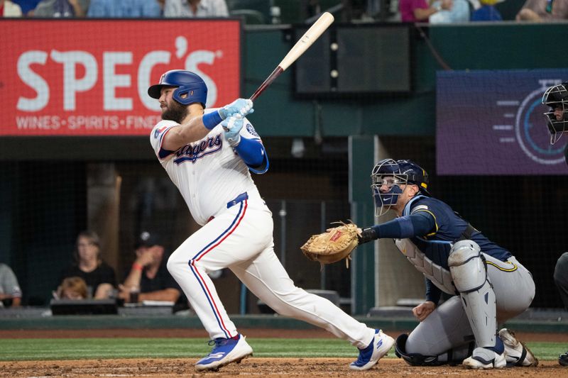 Sep 10, 2025; Arlington, Texas, USA; Texas Rangers first baseman Jake Burger (21) follows through on his two-run home run against the Milwaukee Brewers during the fifth inning at Globe Life Field. Mandatory Credit: Jim Cowsert-Imagn Images