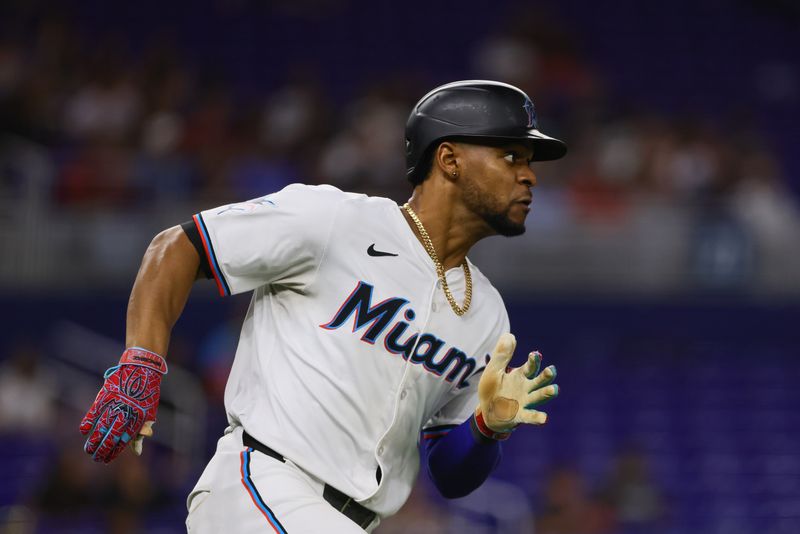 Sep 4, 2024; Miami, Florida, USA; Miami Marlins second baseman Otto Lopez (61) runs toward second base after hitting an RBI double against the Washington Nationals during the seventh inning at loanDepot Park. Mandatory Credit: Sam Navarro-Imagn Images