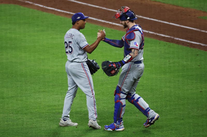 Oct 16, 2023; Houston, Texas, USA; Texas Rangers relief pitcher Jose Leclerc (25) and catcher Jonah Heim (28) celebrate after defeating the Houston Astros in game two of the ALCS for the 2023 MLB playoffs at Minute Maid Park. Mandatory Credit: Troy Taormina-USA TODAY Sports