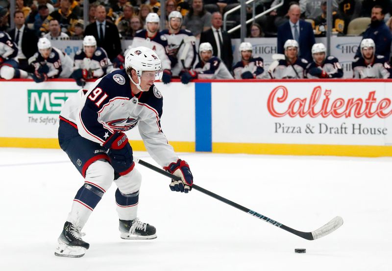 Oct 4, 2024; Pittsburgh, Pennsylvania, USA;  Columbus Blue Jackets center Kent Johnson (91) skates with the puck on a breakaway against the Pittsburgh Penguins during the second period at PPG Paints Arena. Mandatory Credit: Charles LeClaire-Imagn Images