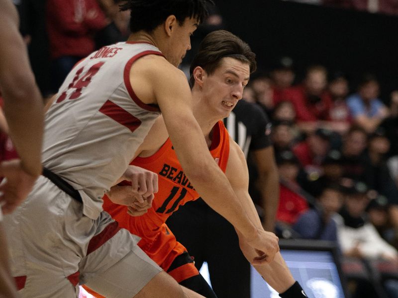 Jan 19, 2023; Stanford, California, USA; Oregon State Beavers forward Dzmitry Ryuny (11) tries to dribble around Stanford Cardinal forward Spencer Jones (14) during the first half at Maples Pavilion. Mandatory Credit: D. Ross Cameron-USA TODAY Sports