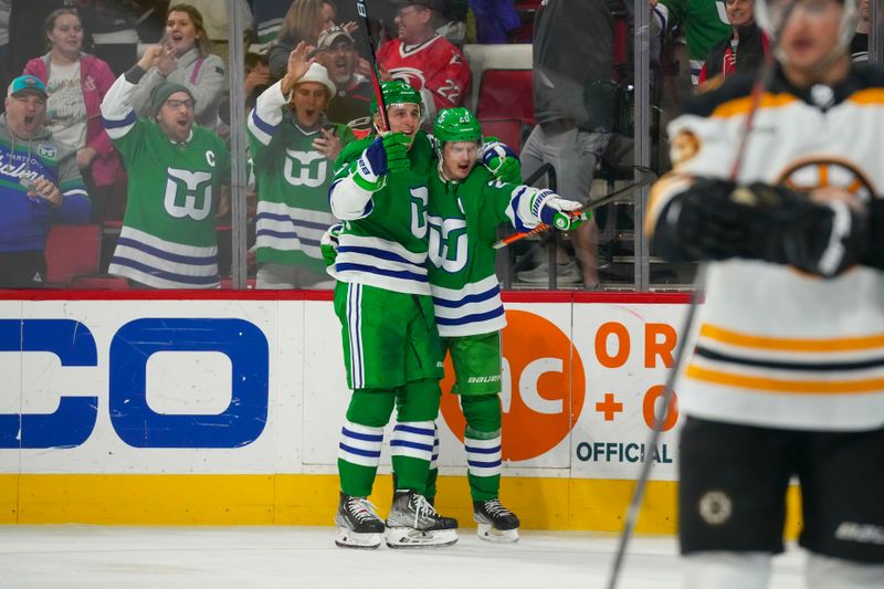 Mar 26, 2023; Raleigh, North Carolina, USA;  Carolina Hurricanes center Sebastian Aho (20) is congratulated by   defenseman Brady Skjei (76) after his goal against the Boston Bruins during the third period at PNC Arena. Mandatory Credit: James Guillory-USA TODAY Sports