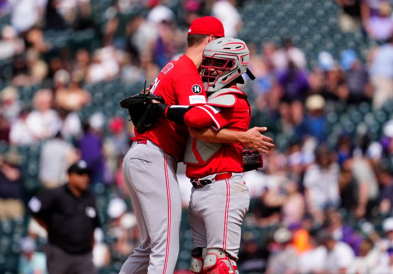 Apr 27, 2025; Denver, Colorado, USA; Cincinnati Reds catcher Jose Trevino (35 and relief pitcher Brent Suter (31) celebrate defeating the Colorado Rockies at Coors Field. Mandatory Credit: Ron Chenoy-Imagn Images