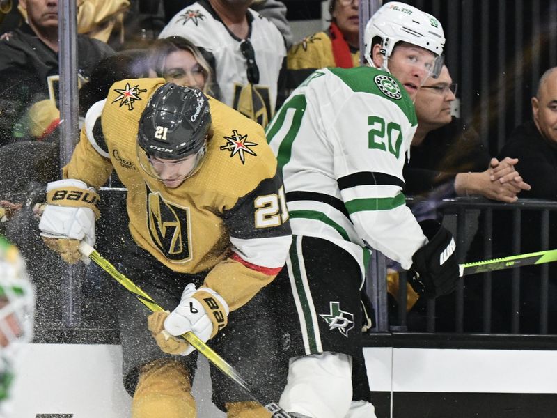 Apr 27, 2024; Las Vegas, Nevada, USA; Vegas Golden Knights center Brett Howden (21) is checked by Dallas Stars defenseman Ryan Suter (20) in the first period in game three of the first round of the 2024 Stanley Cup Playoffs at T-Mobile Arena. Mandatory Credit: Candice Ward-USA TODAY Sports