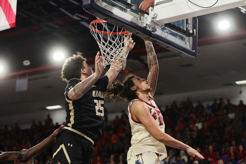 Jan 14, 2024; Boca Raton, Florida, USA; Florida Atlantic Owls forward Tre Carroll (25) drives to the basket against UAB Blazers forward Will Shaver (25) during the second half at Eleanor R. Baldwin Arena. Mandatory Credit: Sam Navarro-USA TODAY Sports