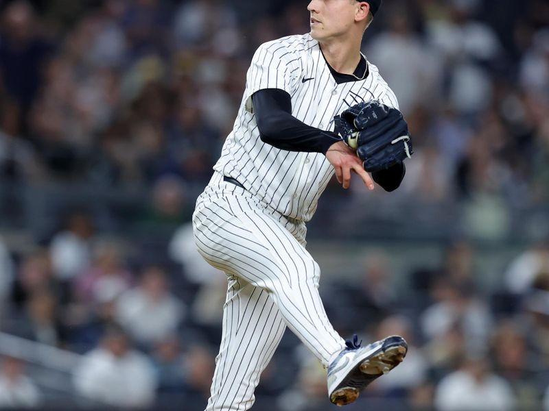 May 7, 2025; Bronx, New York, USA; New York Yankees relief pitcher Luke Weaver (30) follows through on a pitch against the San Diego Padres during the ninth inning at Yankee Stadium. Mandatory Credit: Brad Penner-Imagn Images