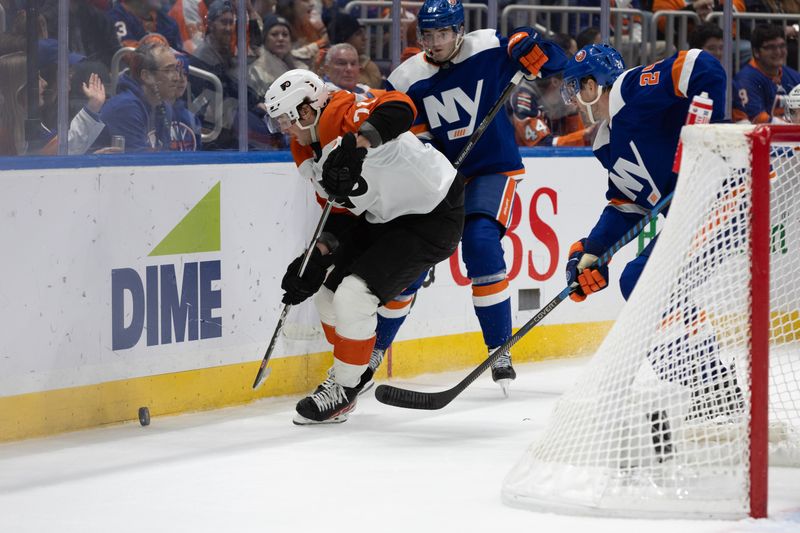 Nov 25, 2023; Elmont, New York, USA; Philadelphia Flyers right wing Tyson Foerster (71) and New York Islanders defenseman Noah Dobson (8) skate towards the puck behind the net during the third period at UBS Arena. Mandatory Credit: Thomas Salus-USA TODAY Sports