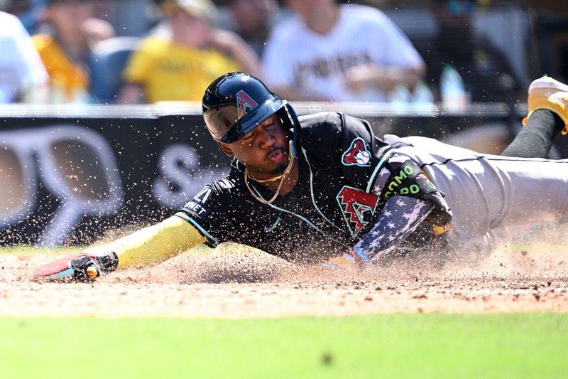 Jul 7, 2024; San Diego, California, USA; Arizona Diamondbacks shortstop Geraldo Perdomo (2) slides home to score a run on a three-RBI double hit by third baseman Eugenio Suarez (not pictured) during the ninth inning against the San Diego Padres at Petco Park. Mandatory Credit: Orlando Ramirez-USA TODAY Sports