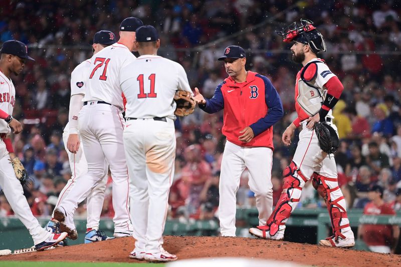 Jul 28, 2024; Boston, Massachusetts, USA; Boston Red Sox manager Alex Cora (13) relieves pitcher Cam Booser (71) of pitching duties during the seventh inning against the New York Yankees  at Fenway Park. Mandatory Credit: Eric Canha-USA TODAY Sports