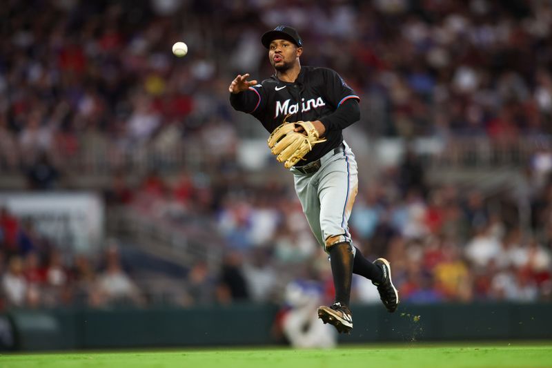 Aug 3, 2024; Atlanta, Georgia, USA; Miami Marlins shortstop Xavier Edwards (63) throws a runner out at first against the Atlanta Braves in the fifth inning at Truist Park. Mandatory Credit: Brett Davis-USA TODAY Sports