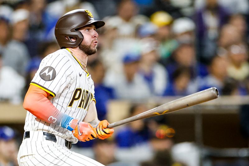 Jun 9, 2025; San Diego, California, USA; San Diego Padres center fielder Jackson Merrill (3) hits an RBI double during the tenth inning against the Los Angeles Dodgers at Petco Park. Mandatory Credit: David Frerker-Imagn Images