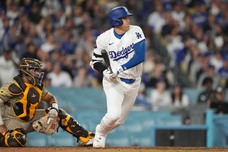 Sep 25, 2024; Los Angeles, California, USA; Los Angeles Dodgers designated hitter Shohei Ohtani (17) hits an RBI single in the sixth inning against the San Diego Padres at Dodger Stadium. Mandatory Credit: Kirby Lee-Imagn Images