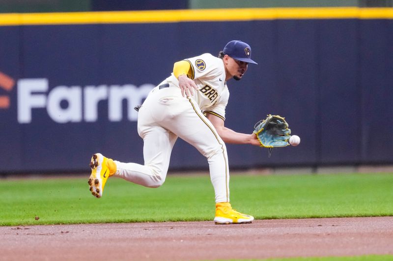 Sep 17, 2024; Milwaukee, Wisconsin, USA;  Milwaukee Brewers shortstop Willy Adames (27) fields a ground ball during the first inning against the Philadelphia Phillies at American Family Field. Mandatory Credit: Jeff Hanisch-Imagn Images