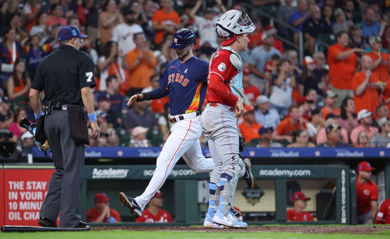 Jun 18, 2023; Houston, Texas, USA; Houston Astros right fielder Kyle Tucker (30) scores a run past Cincinnati Reds catcher Tyler Stephenson (37) during the first inning at Minute Maid Park. Mandatory Credit: Troy Taormina-USA TODAY Sports