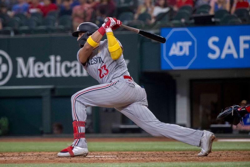 Sep 3, 2023; Arlington, Texas, USA; Minnesota Twins third baseman Royce Lewis (23) hits a single and drives in the tying run against the Texas Rangers during the eighth inning at Globe Life Field. Mandatory Credit: Jerome Miron-USA TODAY Sports